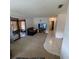 Living room with TV, sofa, and view into hallway at 10300 Sw 98Th Ter, Ocala, FL 34481