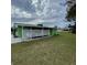 Carport and side yard of a light green home at 10300 Sw 98Th Ter, Ocala, FL 34481