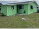 Rear view of a light green single-story home at 10300 Sw 98Th Ter, Ocala, FL 34481