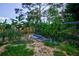 Landscaped backyard with garden and debris at 567 Silver Course Run, Ocala, FL 34472