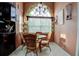 Bright breakfast nook with a round table and wicker chairs at 567 Silver Course Run, Ocala, FL 34472