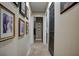 Long hallway with framed pictures and carpeted floor at 567 Silver Course Run, Ocala, FL 34472