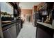 Kitchen with dark wood cabinets, stainless steel appliances, and tile flooring at 567 Silver Course Run, Ocala, FL 34472