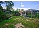 Backyard with pool, screened enclosure, and chicken coop at 567 Silver Course Run, Ocala, FL 34472