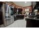 Spacious kitchen with dark wood cabinets, stainless steel appliances, and tile flooring at 567 Silver Course Run, Ocala, FL 34472