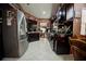 Kitchen with dark wood cabinets, stainless steel appliances, and tile flooring at 567 Silver Course Run, Ocala, FL 34472