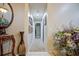 Hallway with carpeted floor, framed pictures on the wall, and a large plant at 567 Silver Course Run, Ocala, FL 34472