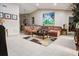 Spacious living room with tiled floors, sectional sofa, and large artwork at 567 Silver Course Run, Ocala, FL 34472