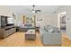 Bright living room with hardwood floors, comfy sofas, and a ceiling fan at 7994 Se 174Th Belhaven Loop, The Villages, FL 32162