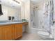 Bathroom with tub shower combo and wood vanity at 7994 Se 174Th Belhaven Loop, The Villages, FL 32162