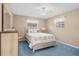 Guest bedroom with light wood furniture and blue carpet at 7994 Se 174Th Belhaven Loop, The Villages, FL 32162
