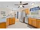 Modern kitchen with stainless steel appliances and wood cabinets at 7994 Se 174Th Belhaven Loop, The Villages, FL 32162
