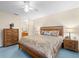 Bright bedroom with ensuite bathroom access and wood furniture at 7994 Se 174Th Belhaven Loop, The Villages, FL 32162