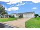 Single story home with garage and landscaped yard at 7994 Se 174Th Belhaven Loop, The Villages, FL 32162