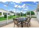 Cozy screened porch with patio furniture, perfect for outdoor dining at 7994 Se 174Th Belhaven Loop, The Villages, FL 32162