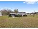 Spacious backyard with grassy area and screened patio at 10881 Sw 79Th Ter, Ocala, FL 34476