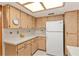 White refrigerator and wood cabinets are featured in this kitchen at 10881 Sw 79Th Ter, Ocala, FL 34476