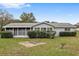 Ranch style home with a screened porch and a nicely landscaped yard at 10881 Sw 79Th Ter, Ocala, FL 34476