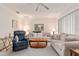 Spacious living room with ample natural light and a ceiling fan at 10881 Sw 79Th Ter, Ocala, FL 34476