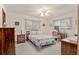 Spacious bedroom with a ceiling fan, double bed, and built-in dresser at 10881 Sw 79Th Ter, Ocala, FL 34476