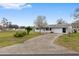 Single-story home with a long driveway and mature landscaping at 10881 Sw 79Th Ter, Ocala, FL 34476