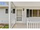 Home features a charming front entrance with storm door at 10881 Sw 79Th Ter, Ocala, FL 34476