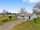 Single-story home, long driveway, and landscaping at 10881 Sw 79Th Ter, Ocala, FL 34476
