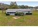 Backyard of home with grassy area and screened porch at 10881 Sw 79Th Ter, Ocala, FL 34476
