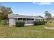 Ranch style home with a large screened porch and lush landscaping at 10881 Sw 79Th Ter, Ocala, FL 34476