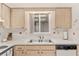 Kitchen with light wood cabinets, double sink, and a window overlooking the backyard at 10881 Sw 79Th Ter, Ocala, FL 34476