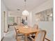 Well lit dining room with wood table and chairs at 10881 Sw 79Th Ter, Ocala, FL 34476