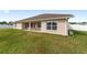 Back of one-story house featuring a covered patio at 3235 Se 43Rd Ave, Ocala, FL 34480