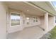 Covered patio with multiple windows and access door to backyard at 3235 Se 43Rd Ave, Ocala, FL 34480