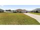 Front view of a house with a large lawn and driveway at 3235 Se 43Rd Ave, Ocala, FL 34480