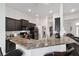 Modern kitchen with dark cabinetry, granite countertops, and stainless steel appliances at 3235 Se 43Rd Ave, Ocala, FL 34480