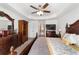 Spacious main bedroom with a large bed, dresser, and walk-in closet at 3235 Se 43Rd Ave, Ocala, FL 34480