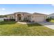 Front view of a single-story house with a two-car garage at 3235 Se 43Rd Ave, Ocala, FL 34480