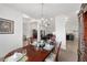 Elegant dining room with chandelier, large windows and view of kitchen at 3235 Se 43Rd Ave, Ocala, FL 34480