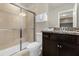 Bathroom with granite countertop, dark brown vanity, and shower at 3004 Mahalo Dr, Davenport, FL 33897