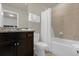 Bathroom with granite countertop, dark wood vanity, and a bathtub at 3004 Mahalo Dr, Davenport, FL 33897