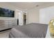 Bedroom with a gray upholstered bed, dresser, and access to other rooms at 3004 Mahalo Dr, Davenport, FL 33897