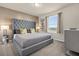 Main bedroom with a gray upholstered bed, window with blinds, and carpet flooring at 3004 Mahalo Dr, Davenport, FL 33897