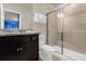Bathroom with granite countertop, dark brown vanity, and a large shower stall at 3004 Mahalo Dr, Davenport, FL 33897