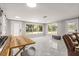 Open concept living room and kitchen with gray tile floors and updated kitchen at 11782 Sw 140Th St, Dunnellon, FL 34432