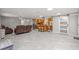 Open concept living room with kitchen, gray tile floors, and a barn door at 11782 Sw 140Th St, Dunnellon, FL 34432