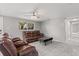 Living room with brown reclining sofas, a coffee table, and access to other rooms at 11782 Sw 140Th St, Dunnellon, FL 34432