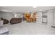 Open living area with kitchen, gray tile floors, and modern appliances at 11782 Sw 140Th St, Dunnellon, FL 34432