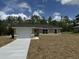 Newly built home with attached garage and driveway at 233 Locust Ln, Ocala, FL 34472