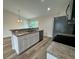 Open kitchen with island and stainless steel appliances at 233 Locust Ln, Ocala, FL 34472