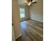 Well-lit bedroom with wood-look floors and ceiling fan at 233 Locust Ln, Ocala, FL 34472